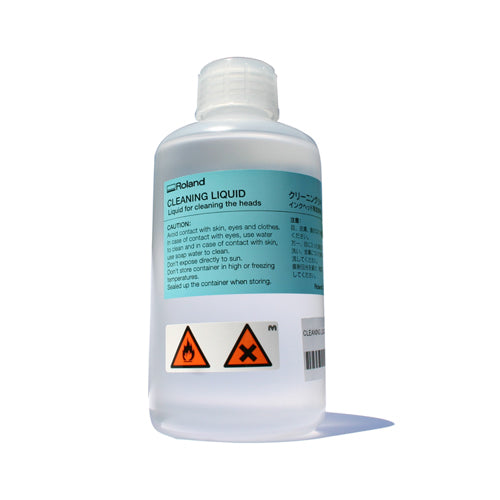 A 500ml bottle of Roland cleaning liquid with a label and safety warnings.