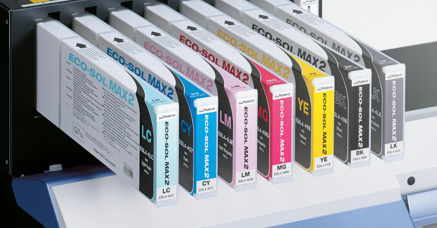A set of Roland DG ECO Sol MAX 2 ink cartridges in various colors, including cyan, magenta, yellow, and black, displayed in a row.