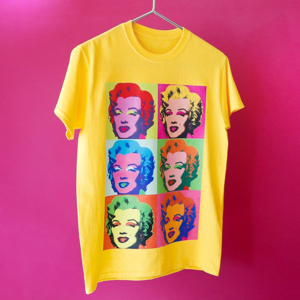 Yellow t-shirt with a B-Flex Print01 colourful graphic of a face on a pink background